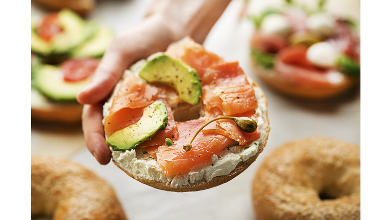Holding healthy bagel sandwich