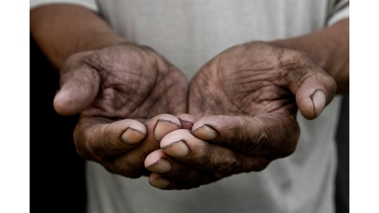 The poor old man's hands beg you for help. The concept of hunger or poverty. Selective focus. Poverty in retirement. Alms
