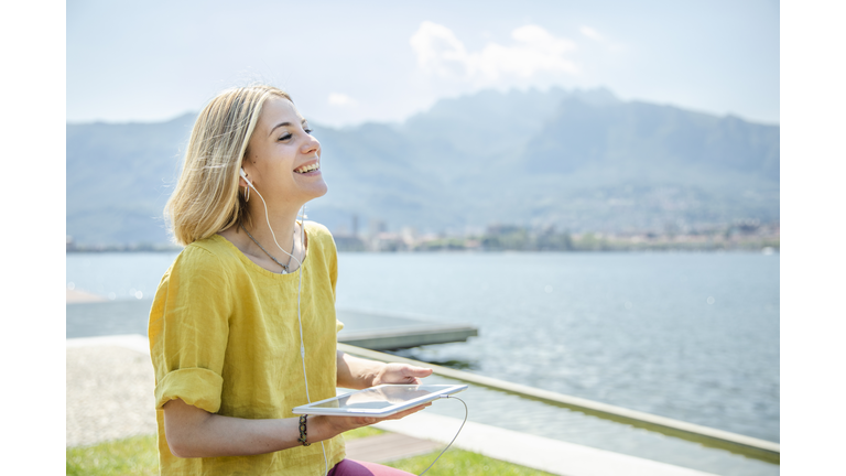 Young Woman Listening Podcast with Digital Tablet