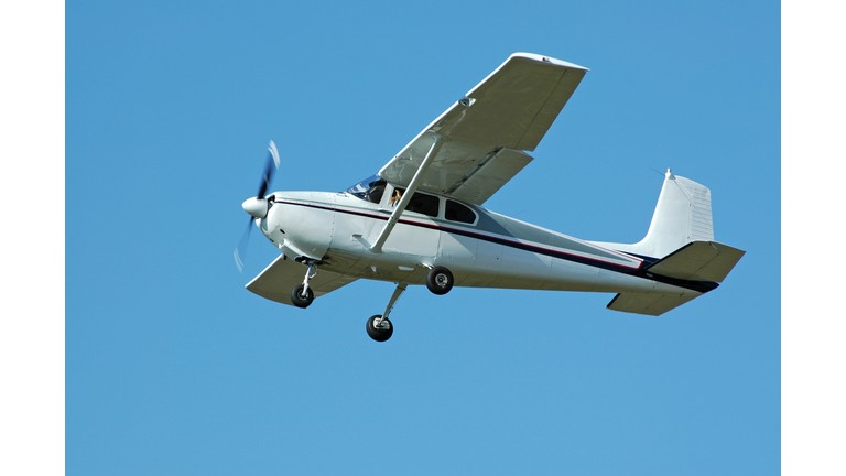 private airplane Cessna 182 flying in clear blue sky