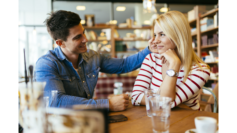 Beautiful couple in love flirting in cafe