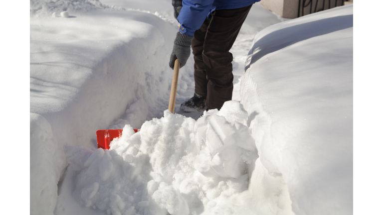 Shoveling Removing Snow at Residential Home After Winter Blizzard Storm