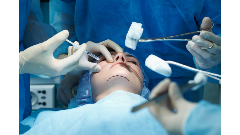 Young woman having facial plastic surgery