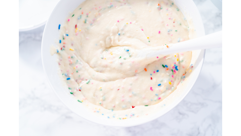 Mixing ingredients to bake birthday funfetti cake