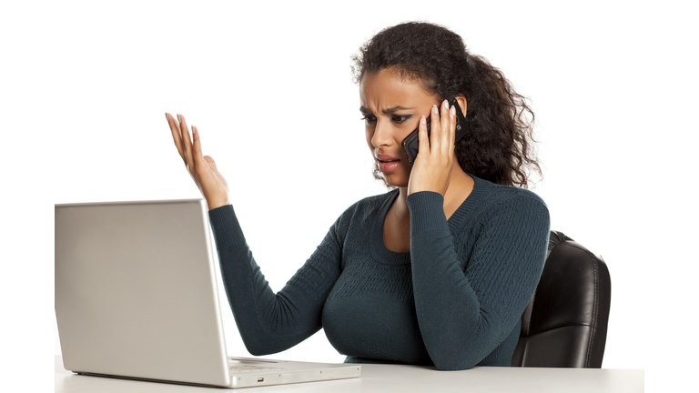 Angry dark skinned student talking on phone with customer service