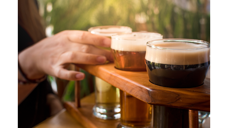 Cropped Image Of Woman Tasting Craft Beer At Bar