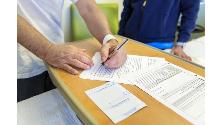 Man signs hospital release forms