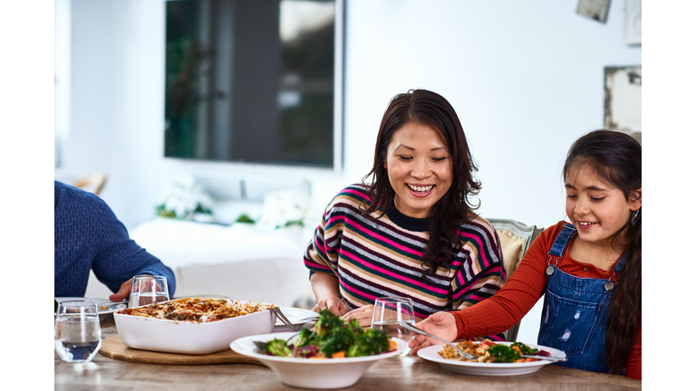 Young girl and mother enjoying healthy meal together