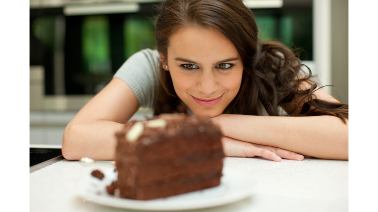 Woman staring at chocolate cake