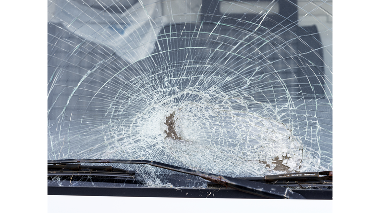 Shattered windshield after car crash. Vehicle accident. Broken glass.