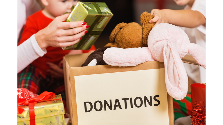 Family donating gifts and toys to charity for Christmas holiday