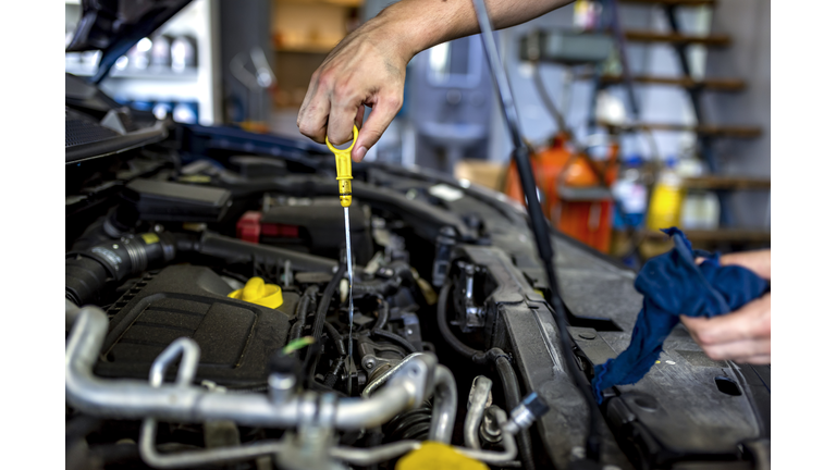 Mechanic checking oil