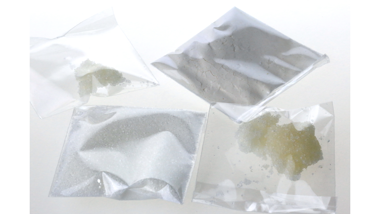 Individual bags of illegal drugs on a white background