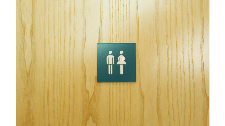 Male and female toilet sign on door