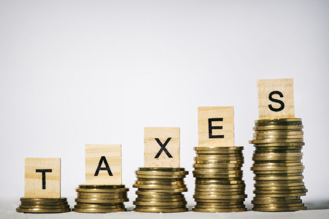 Single Word Taxes On Wooden Block