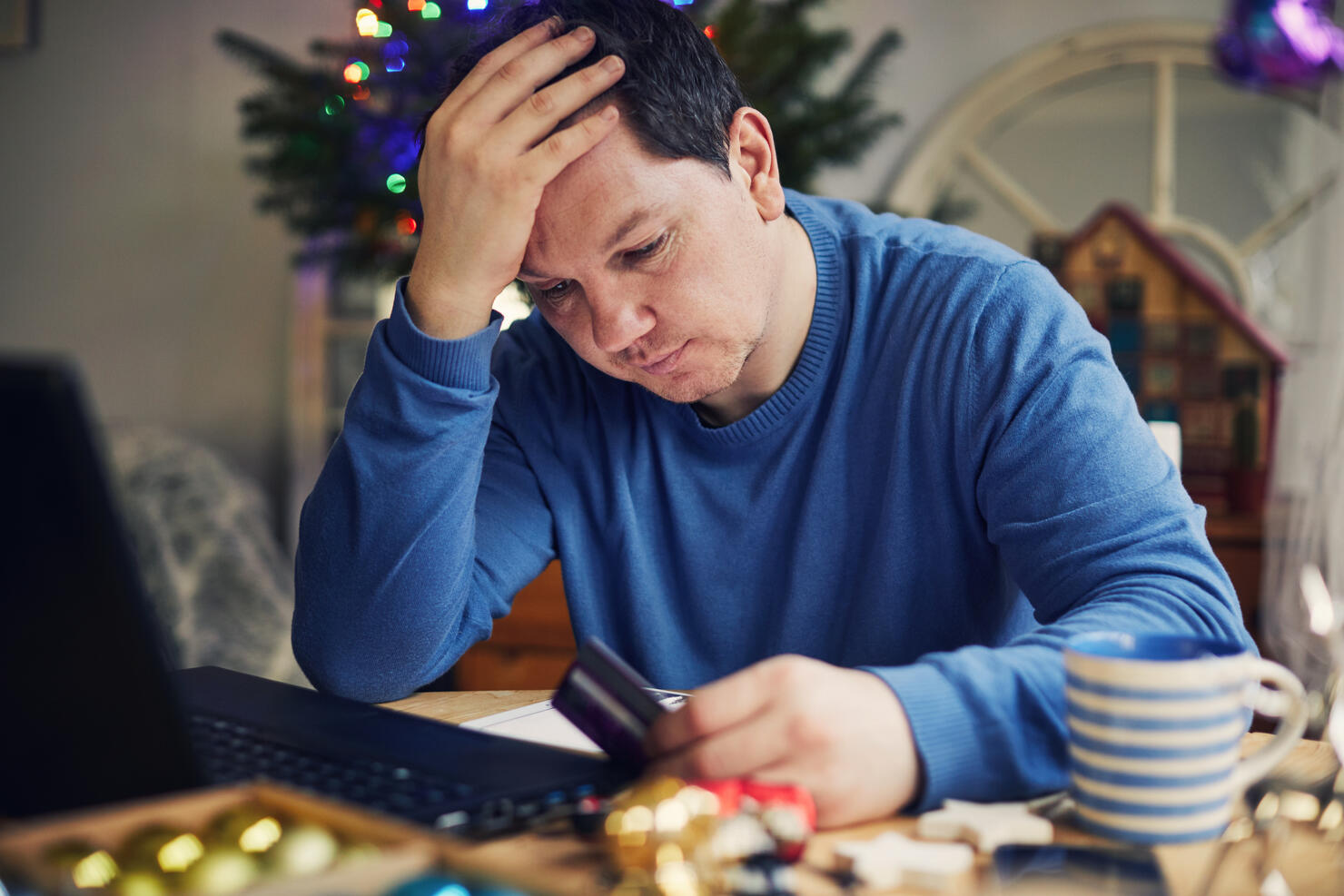 Man Christmas shopping using a laptop