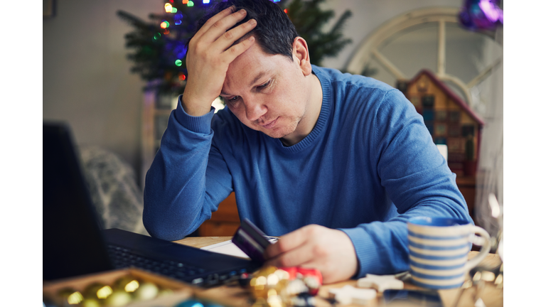 Man Christmas shopping using a laptop