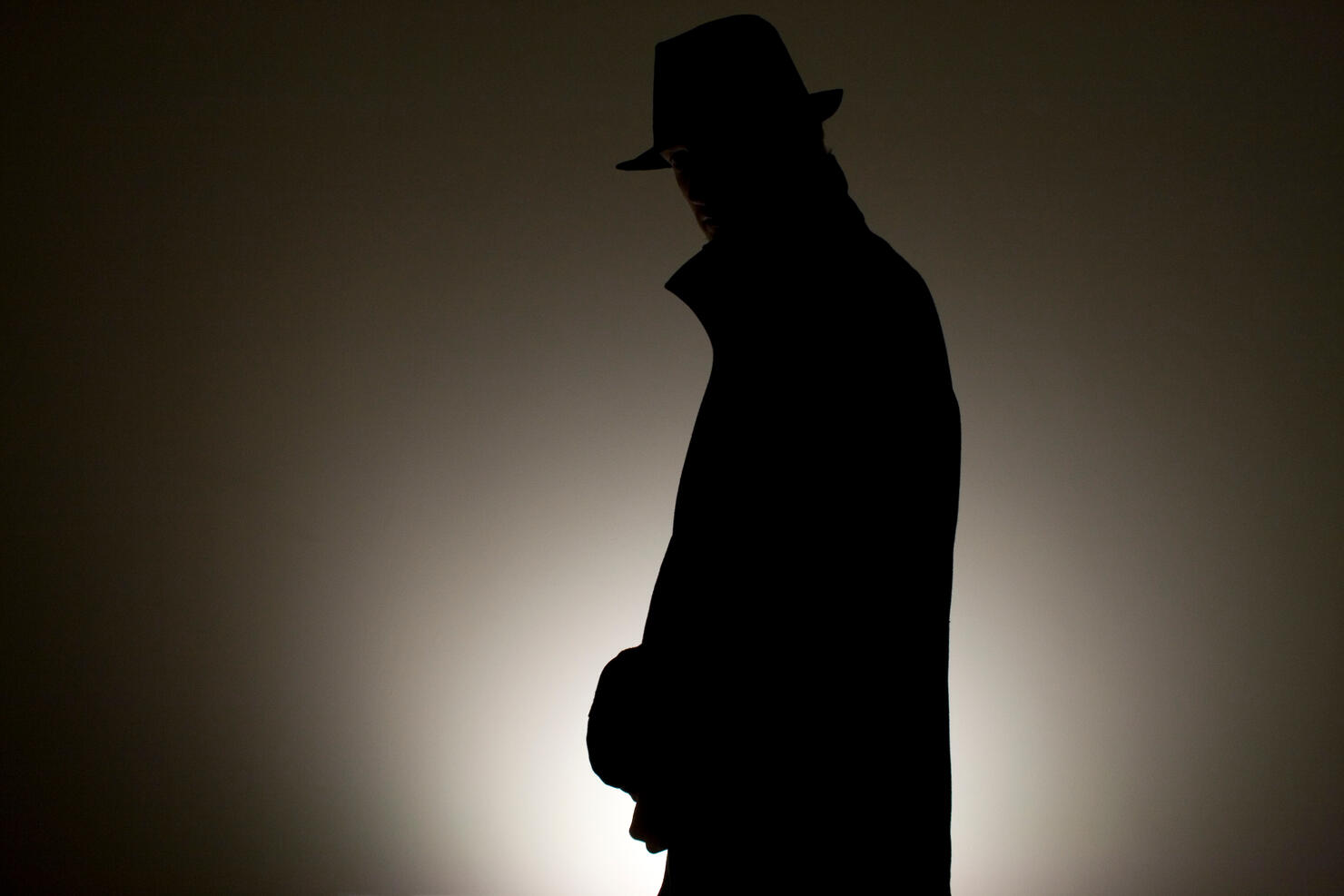 Detective Wearing Hat Against Wall In Room