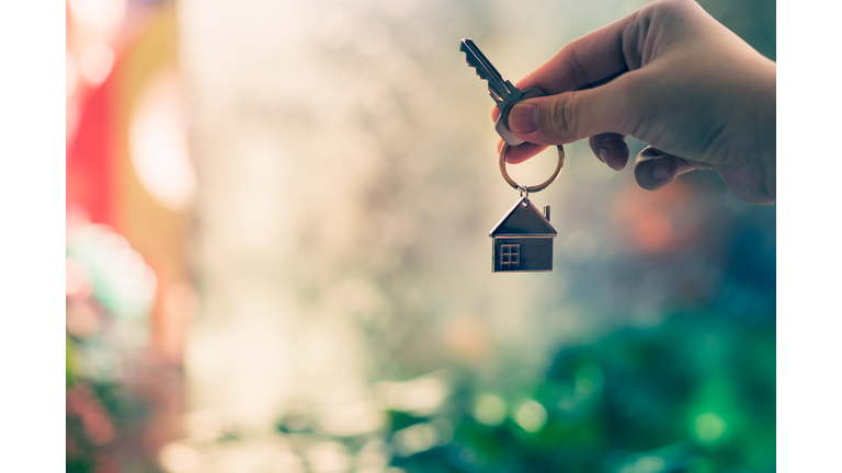 House model and key in home insurance broker agent  hand or in salesman person. Real estate agent offer house, property insurance and security, affordable housing concepts