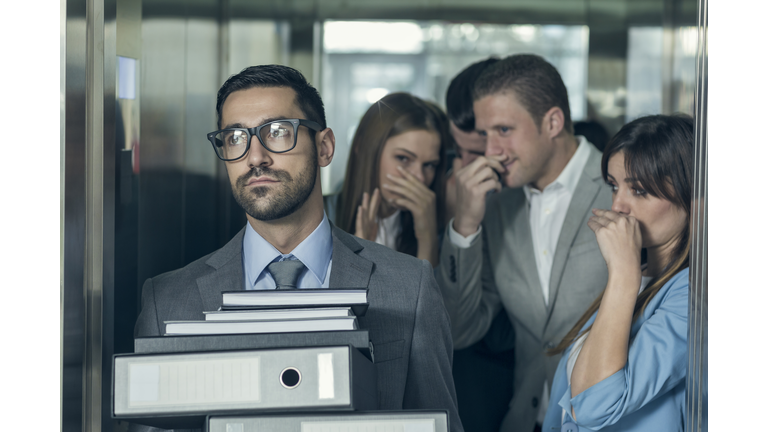 Smelly businessman affecting his coworkers in an elevator