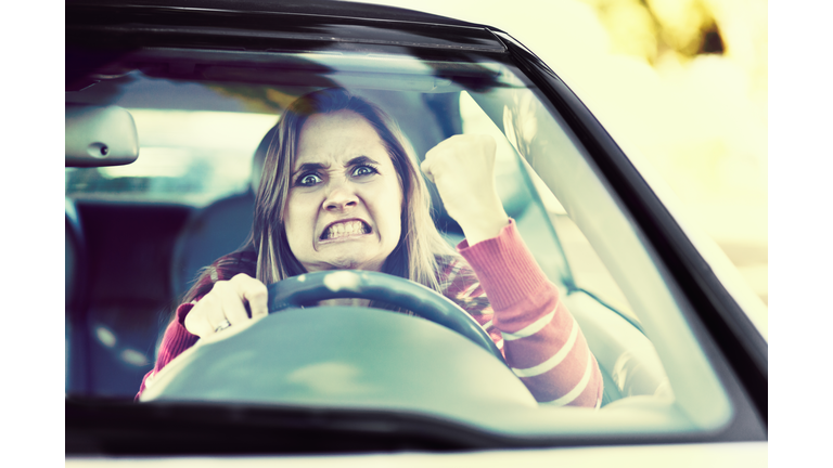 Losing her temper, a woman driver shakes fist through windshield