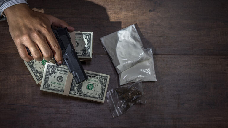 Drug trafficking, crime, addiction close up of hands with drugs and money