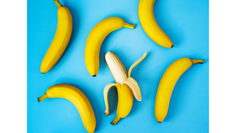 Ripe bananas on blue background