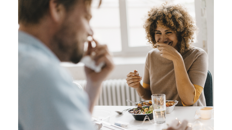 Colleagues joking at lunch break, eating healthy food