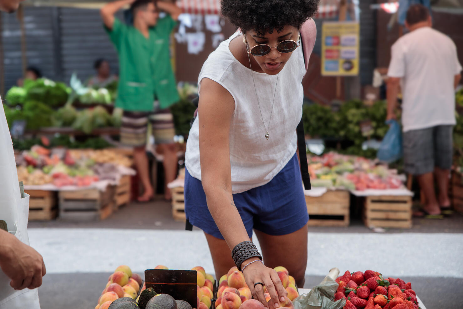 Woman shopping for fruits at a street market in the city of Rio de Janeiro