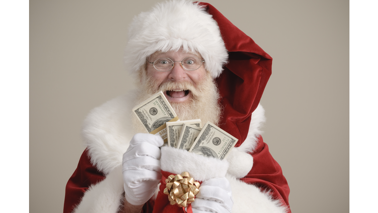 Santa holding a stocking filled with money