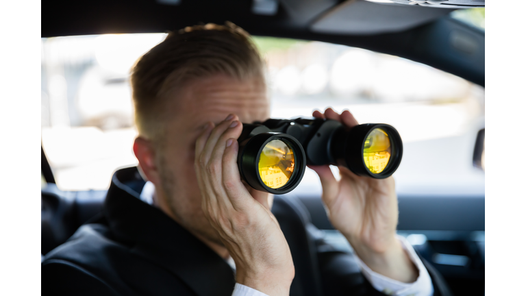 Man Looking Through Binocular