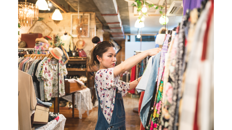 Young woman shopping in a vintage clothing store