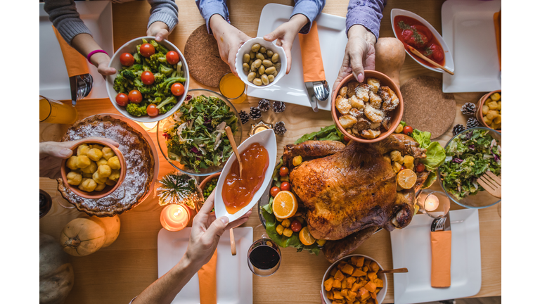 Above view of passing food during Thanksgiving dinner.