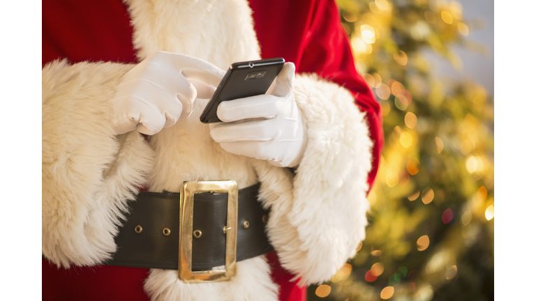 Santa claus holding cell phone