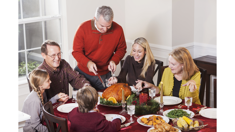 Multi-generation family enjoying holiday turkey dinner