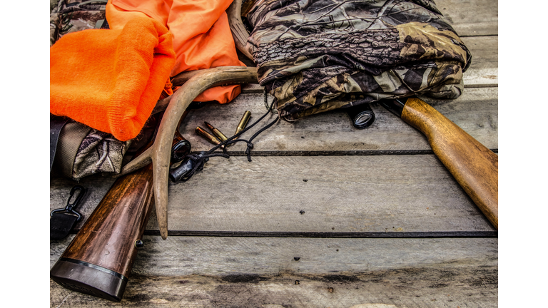 Deer Hunting Gear Background With Rifles, Rattling Antlers, Deer Call And Camouflage