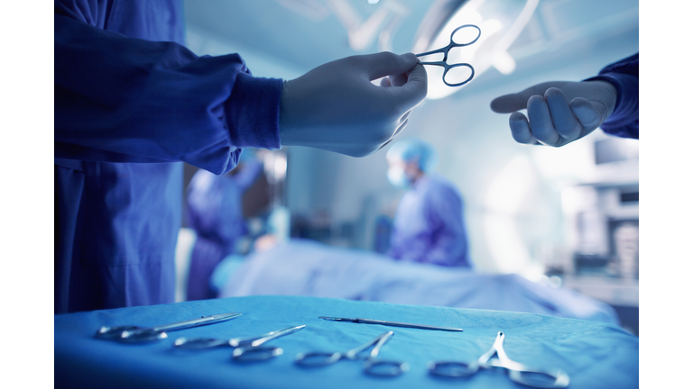 Handing doctor surgical tool in operating room