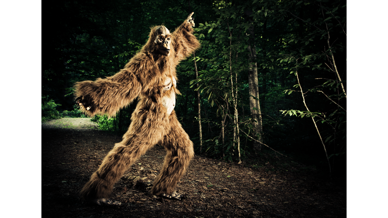 bigfoot making a disco dancing step on the road