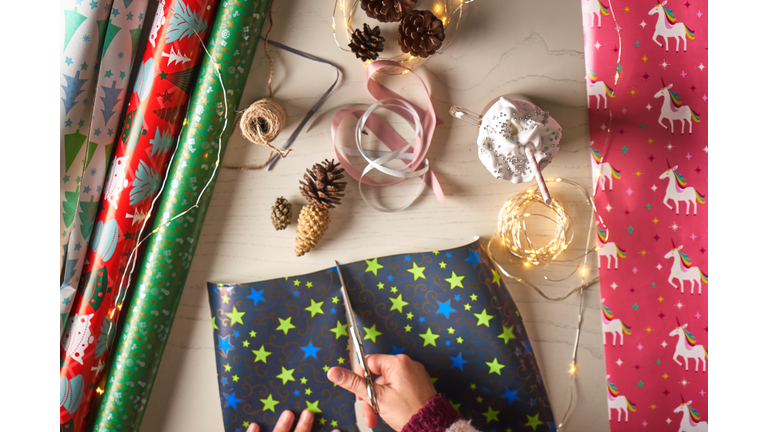 Woman wrapping gifts at home