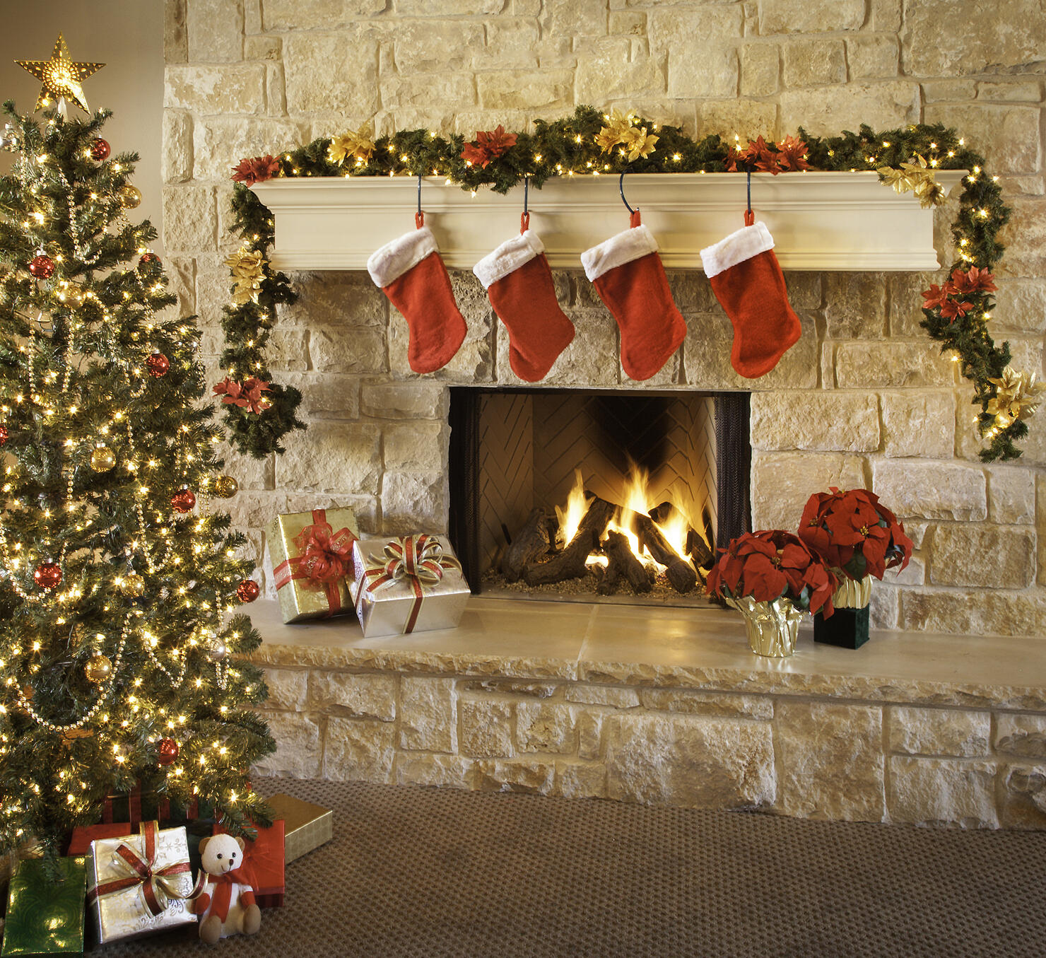 Christmas stockings, fire in fireplace, tree, and decorations