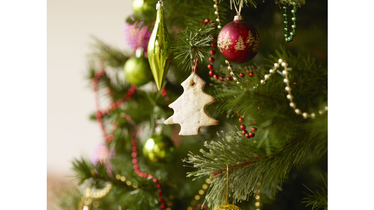 Close up of christmas tree with baubles and christmas biscuits