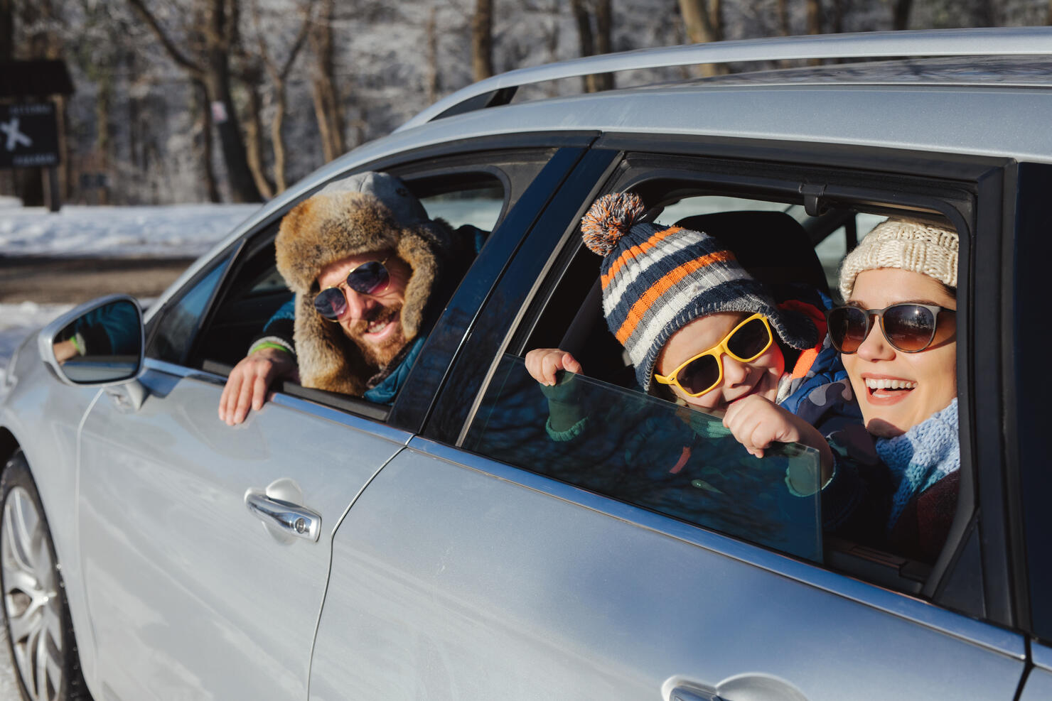 Family enjoying the ride to mountain forest by car