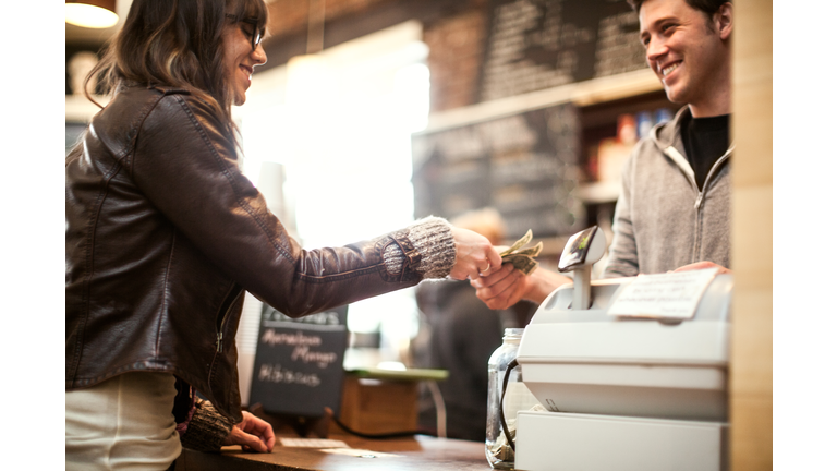 Young woman purchasing coffee