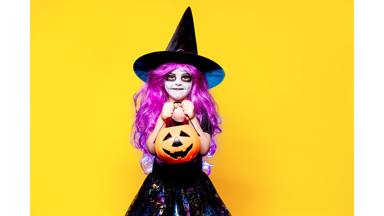 Girl in witch Halloween costume