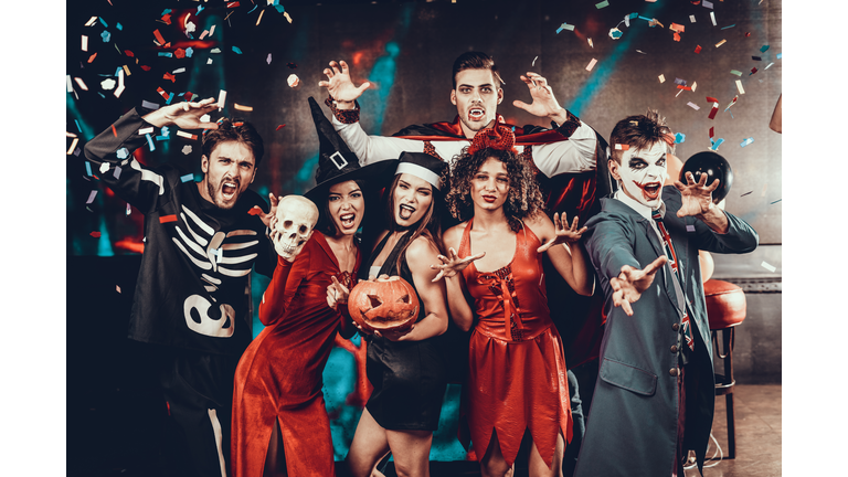 Portrait of Young Smiling People in Scary Costumes