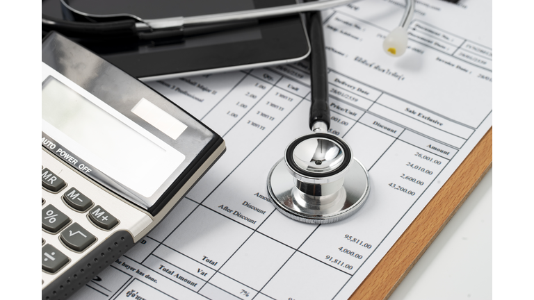 Healthcare costs and fees concept.Hand of smart doctor used a calculator for medical costs in modern hospital