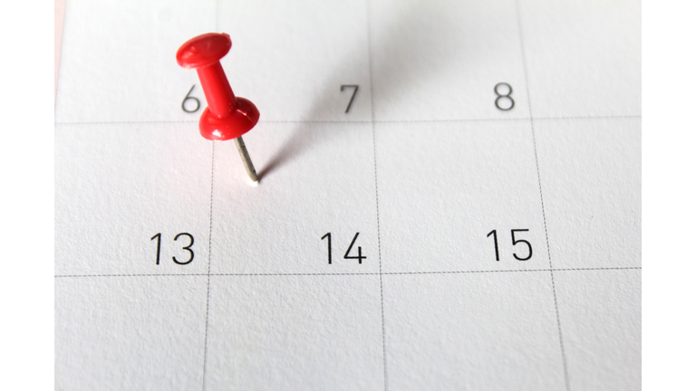 Close-Up Of Red Thumbtack On Calendar