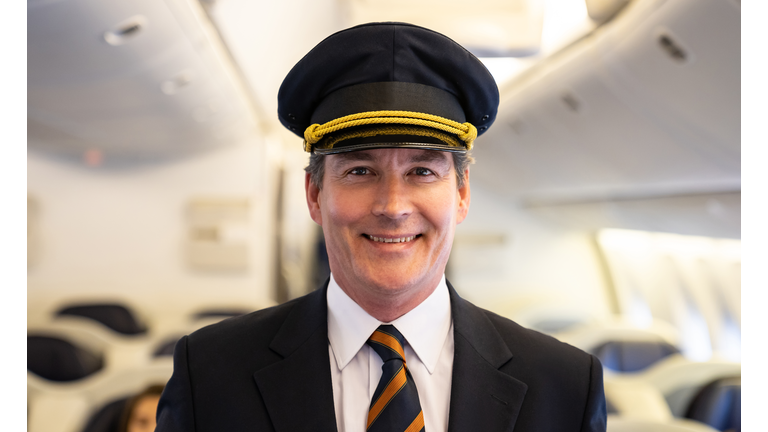 Portrait of a happy pilot in an airplane