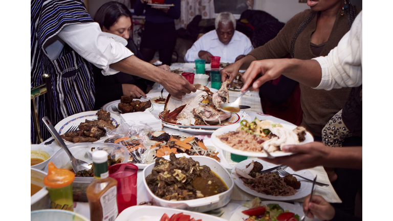 Family serving food at holiday dinner