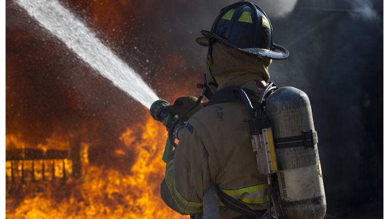 Fireman putting out a bedroom fire